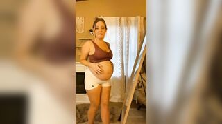 Pregnant changing her clothes