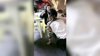 Chinese mistress feeding her dog in public