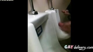 two slim dicks getting wanked at the urinals