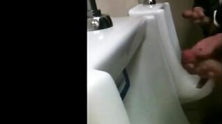 two slim dicks getting wanked at the urinals 2