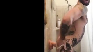 Tatted Hunk Fucks Dildo in Shower Until He Cums